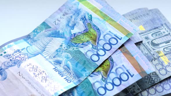 Conversion of banknotes by hand , Kazakhstan tenge currency. alt