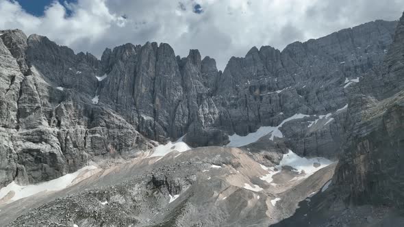 Hikers and travelers enjoy the beautiful mountain views as they have a walk in the Dolomites alt