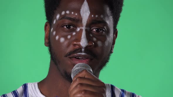 Portrait of Young African American Man Singing Song Into the Microphone alt