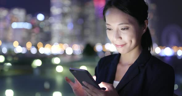 Woman Use Smart Phone in City at Night 