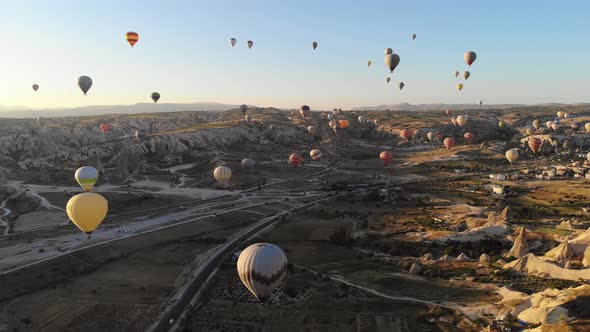 Aerial Hot Air Balloons Flying Over Hoodoos and Fairy Chimneys in Goreme Valley Cappadocia, Turkey alt