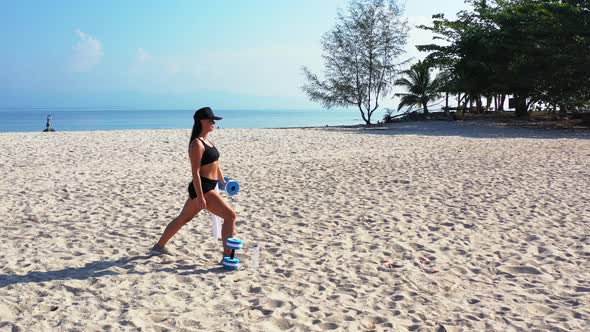 Sexy beauty models on holiday by the sea on beach on clean white sand and blue background 4K alt