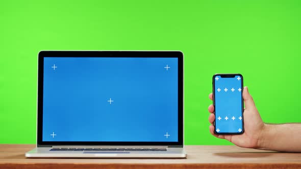 Laptop and Smartphone with Blue Chroma Key on Green Background Closeup alt