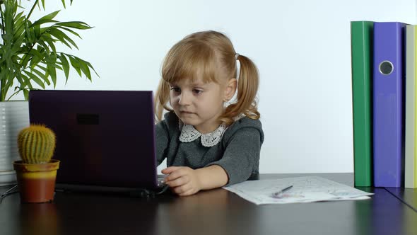 Child Schoolgirl Learn Lessons at Home. Distance Education During Coronavirus Quarantine. E-learning alt