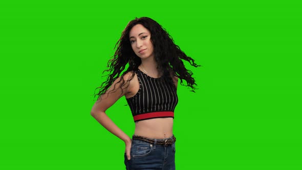 Beautiful fit female holds hands in pockets and turns on green screen alt