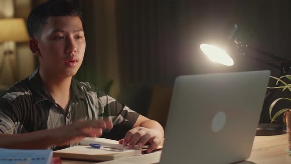 Teenage Boy Learning Online From Laptop, Raising Hand Distance Learning Online alt