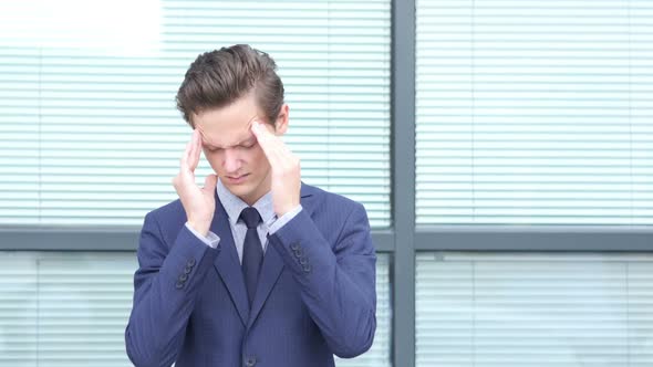 Headache, Upset Gesture by Young Businessman alt