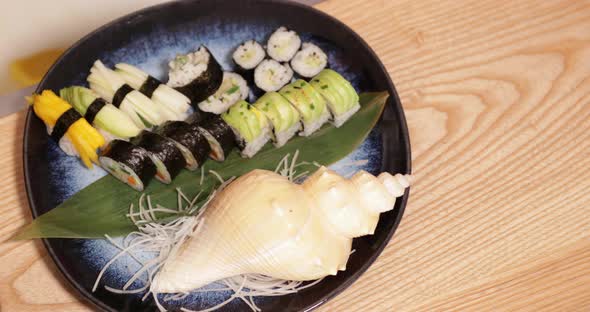 Platter Of Sushi Rolls And Nigiri Sushi Decorated In Seashell In A Japanese Restaurant. - top-down, alt