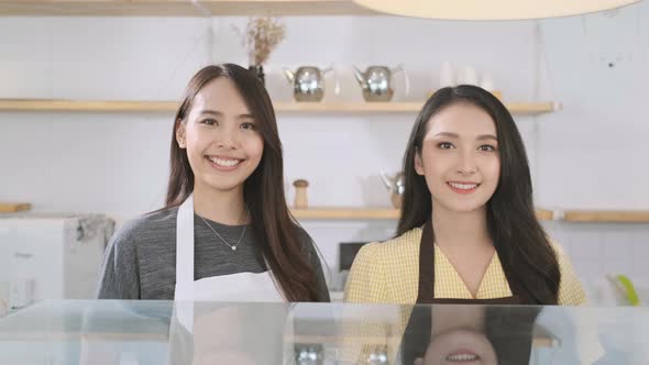 Portrait asian woman  waitresses in aprons in coffee shop. small business owner restaurant concept