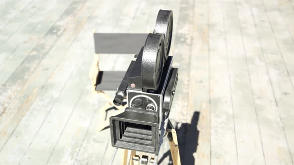 Old, retro, vintage film camera with director chair in the background. 4K HD alt