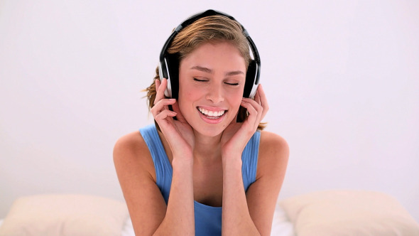 Happy Brunette Listening To Music