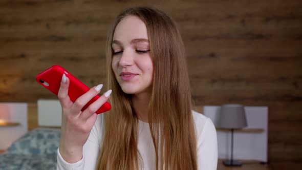 Smiling Young Woman Recording Voice Audio Message to Friends Using Translator on Mobile Phone alt