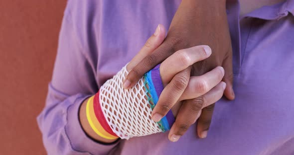 Multiracial lesbian couple holding their hands - Love and Lgbt concept alt
