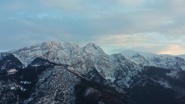 Panorama Of Snowy Tatra Mountain Range With Forest During Winter In Europe. - aerial alt
