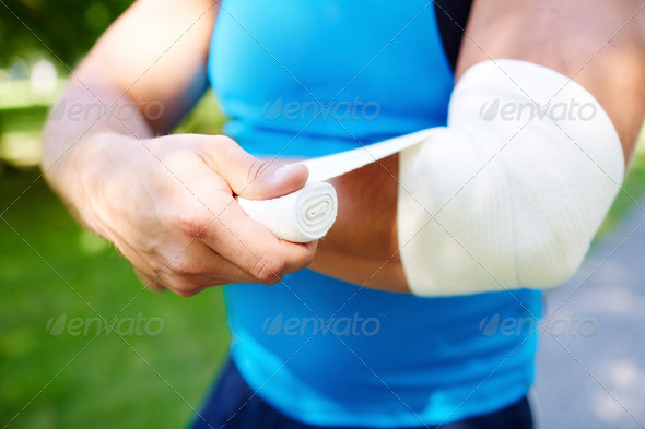 Bandaging arm - Stock Photo - Images