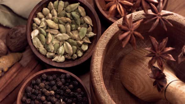 Wood Mortar and Star Anise Spice Species Falling in Slow Motion alt
