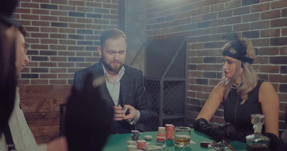 Company of Rich People Getting Ready To Play Poker. Man Lays Out the Cards alt