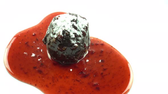 Chocolate ball and fruit sauce sprinkle with powdered sugar on top