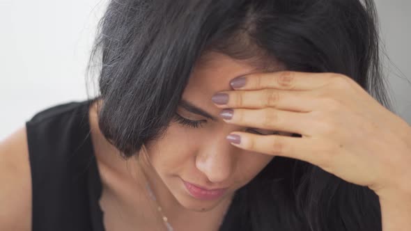 Beautiful young Latina girl enjoys music and smile towards camera while working alt