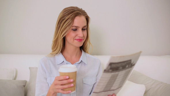 Calm Blonde Woman Reading Newspaper Sitting