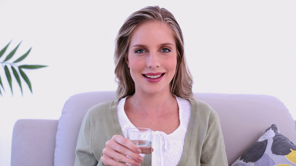 Calm Woman Drinking A Glass Of Water