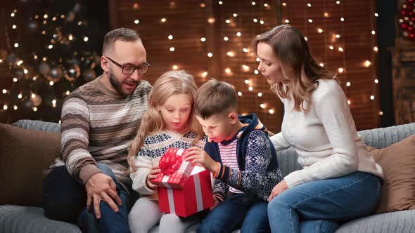 Happy Family Enjoying Christmas Eve Spirit with Presents Together alt