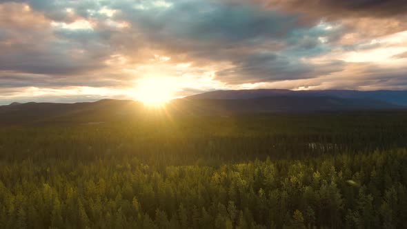 View of Scenic Valley Surrounded By Mountains at Sunset alt