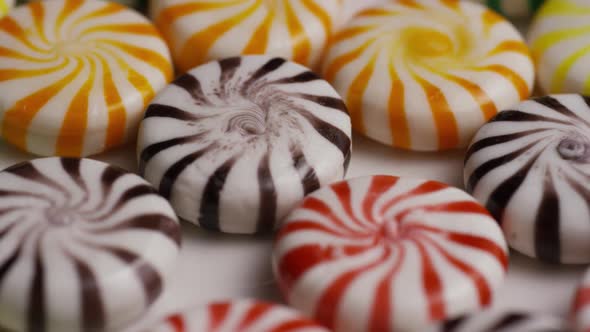 Rotating shot of a colorful mix of various hard candies - CANDY MIXED alt