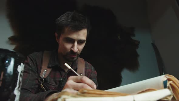 The Man Prepared to Draw Something in a Notebook