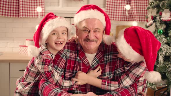 Grandfather and His Grandsons Are Smilling To the Camera on Christmas Holidays