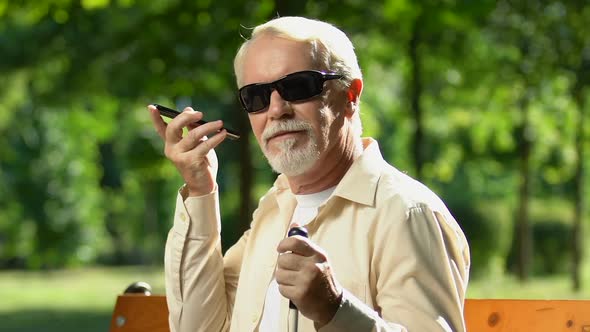 Senior Man With Visual Impairment Talking Through Speakerphone, Voice Commands alt