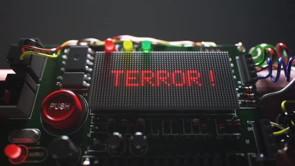 Armed TNT bomb isolated in dark room in spotlight. Terror word on a display.