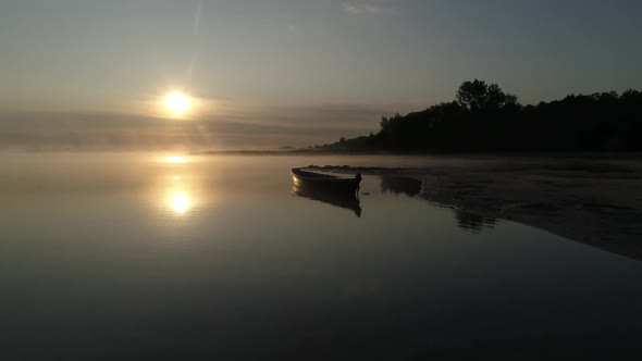 On the Shore of Lake Svityaz a Wooden Boat Meets the Sun in the Fog