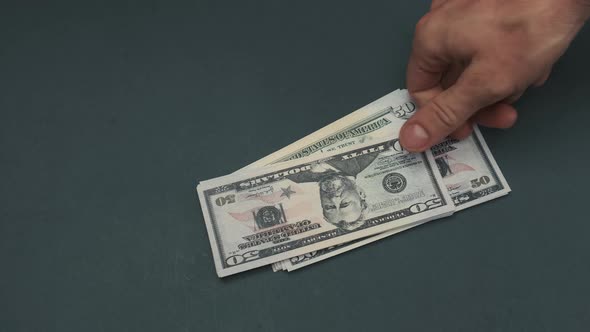 50 Dollar Bills Being Dropped on Table alt