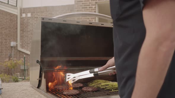 Grilling Burgers Outside In Slow Motion