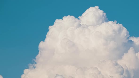 Timelapse of White Puffy Cumulus Clouds Forming on Summer Blue Sky alt