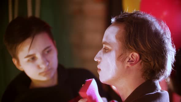 Make-up Artist Applying Paint on the Man Clown in the Dressing Room alt