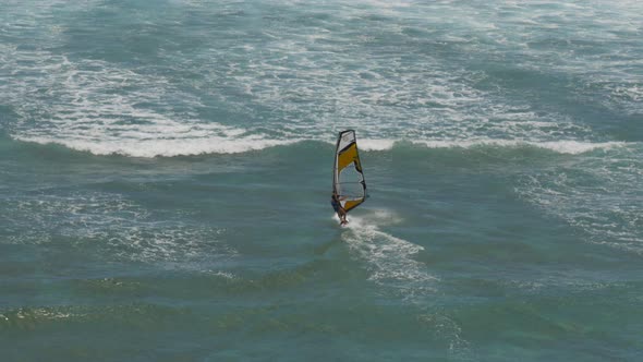 high angle view of a female windsurfer sailing at diamond head alt