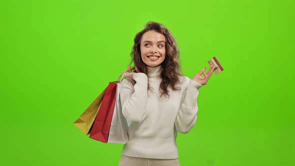 The Woman is Looking at the Camera and Smiling alt