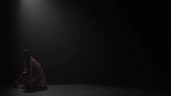 Woman Dancing Contemporary in Studio Under Spotlight. Slow Motion alt