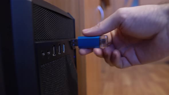 Man Inserts A Usb Flash Drive From A Computer Connector