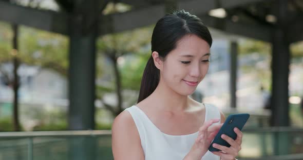 Woman use smart phone at outdoor alt
