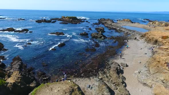 American Beach Aerial Over Rocky Coast with Tourists Exploring alt