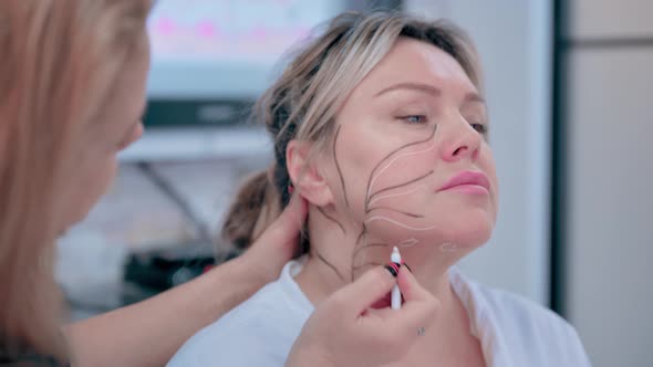 Woman Beautician Makes Markings on the Face for Injection