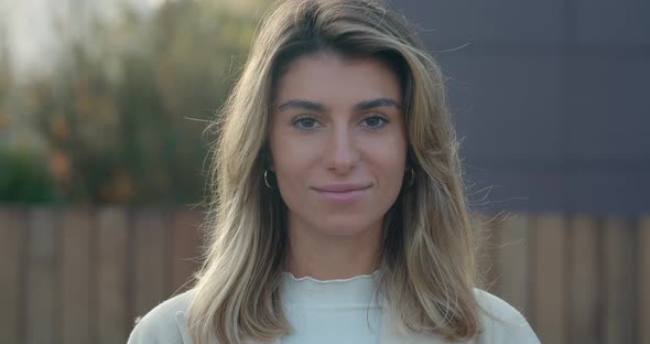 Close Up View of Beautiful Young Woman Looking To Camera and Smiling. Female Pretty Person with alt