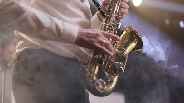 Saxophone Player Playing a Solo in Jazz Band Performing on Lightened Stage