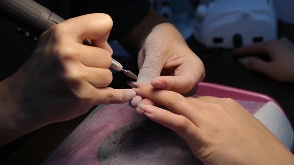 Anonymous Beautician Doing Manicure to Female Client