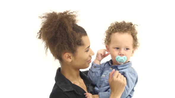 Mom Holds the Baby in the Arms and Cheers Him. White Background alt