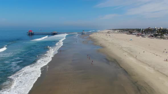 Aerial View of Huntington Pier, Beach and Coastline During Sunny Summer Day alt