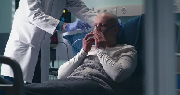 Doctor Supplying Cancer Patient with Oxygen alt